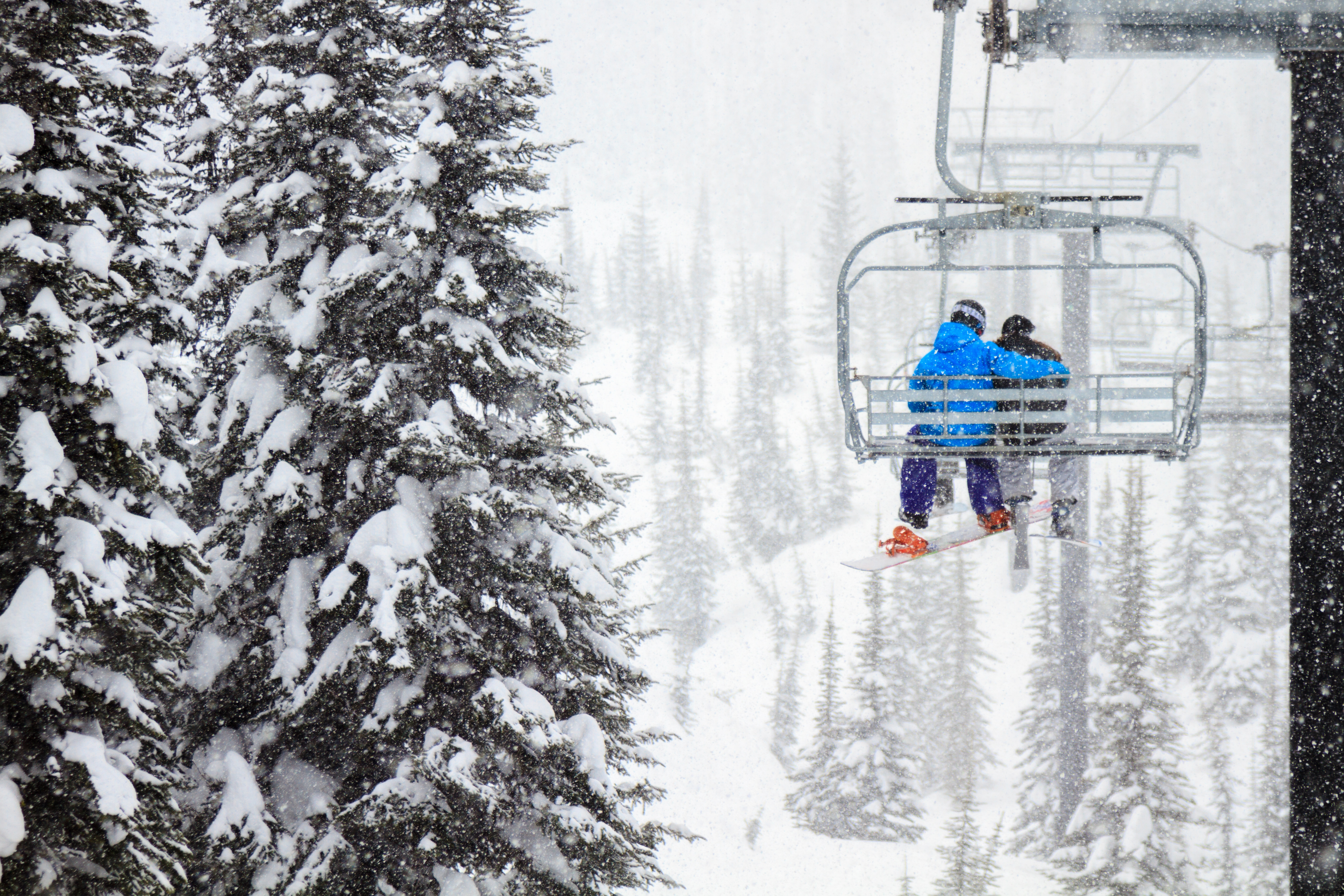 Two skiers on a ski lift